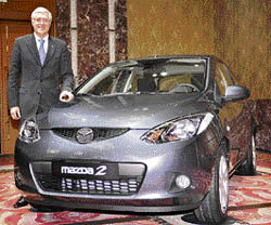 Newly appointed Japanese auto giant Mazda Motor executive vice- president Philip G. Spender introduces the new Mazda 2 three-door hatchback model in Tokyo on Friday.