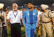 I.S. Bindra takes Harbhajan Singh by the arm to the dressing room at PCA Stadium