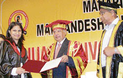 Chief Justice of the Punjab and Haryana High Court Vijender Jain confers a degree on a student during the convocation of MM University at Mulana, near Ambala