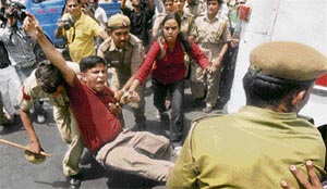Police personnel arrest a resident doctor during a demonstration by doctors against OBC quota in higher education, outside the Supreme Court in New Delhi on Friday.