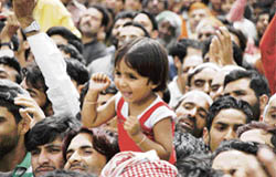 A girl cheers up amidst the gathered crowd at the public rally addressed by Prime Minister Dr Manmohan Singh at Kishtwar 