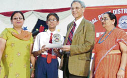 Manjit Singh Kang, vice-chancellor, PAU, gives away a prize to a student during a function at BCM School