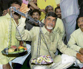 TDP president N Chandrababu Naidu weighs vegetables with a balance during a dharna against price rise jointly organised by the TDP, CPI, CP(M) and SP. 