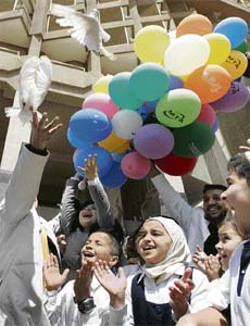 Children applaud as balloons and pigeons are released during celebrations for the first Iraqi childrens day in Baghdad