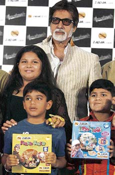 Superstar Amitabh Bachchan poses with children during the launch of Zapak Kids and Bhoothnath movie gaming merchandise in Mumbai