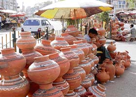 With the mercury rising, earthen water pots are in demand. A vendor displays his wares at the vegetable market in Karnal