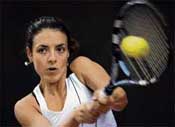 Spains Nuria Llagostera Vives returns the ball to Chinas Peng Shuai during their match of the Fed Cup World Group semifinal between China and Spain in Beijing on Sunday