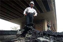 A traffic police officer stands on the site of a suicide attack in Baghdad on Sunday. 
