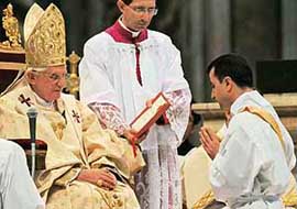 New Iraqi priest Robert Jarjis (Right) pays his respect to Pope Benedict XVI (Left) during a mass for the ordination of 29 new priests on Sunday in St. Peters Basilica at the Vatican.