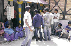 Migrant labourers await their turn for registration outside Palampur police station.