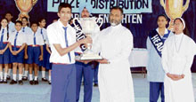 Director of Sacred Heart Senior Secondary School, BRS Nagar, Father Davis distributes prizes among toppers during the prize distribution function organized at the school.