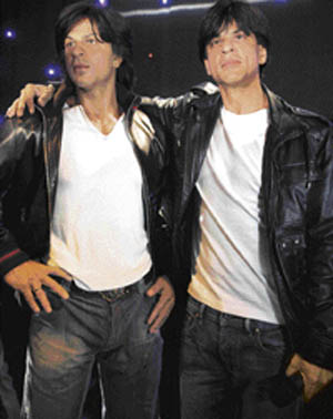 Bollywood star Shah Rukh Khan (right) stands next to his figure at the Grevin wax museum during the presentation of his waxwork in Paris on Monday.