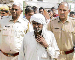 Ram Mehar Saini, who allegedly murdered his three children and wife, in police custody in Kavi village in Panipat district on Tuesday.
