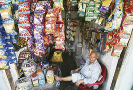 A Kashmiri Pandit at his shop at the Muthi migrant camp on the outskirts of Jammu on Tuesday.