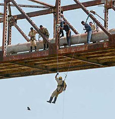 An officer from the National Fire Service College abseils from a bridge during a training session on the outskirts of Ahmedabad on Tuesday. Currently 29 officers from across India are undertaking the six-month-long course during which they are instructed in all aspects of the fire and emergency services ranging from aircraft fire and rescue to shipboard fire hazards.