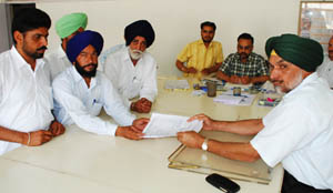 A candidate files his nomination papers before ADC (General) Upjeet Singh Brar in Bathinda on Wednesday. 