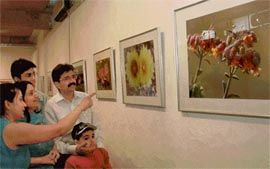 Visitors enjoy a photo exhibition, Floral Mystique, by Dinesh Verma at Govt Museum Art Gallery in Chandigarh on Wednesday.