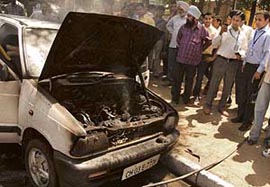 The car that caught fire on the road dividing Sectors 16 and 17 in Chandigarh on Wednesday.