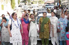 Women block traffic near Chhota Shimla on Wednesday to protest against slow police action in a case of attempt to rape a minor.