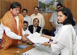 BJP candidate Anurag Thakur submits his nomination papers to returning officer Nandita Gupta at Hamirpur on Wednesday. 