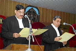 Himachal Chief Justice Jagdish Bhalla (right) administers the oath to Ram Bhawan Mishra as a judge of the High Court at Shimla on Wednesday.