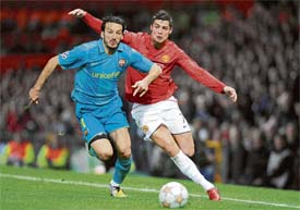 Manchester Uniteds Portuguese midfielder Cristiano Ronaldo (R) fouls Barcelonas Italian defender Gianluca Zambrotta during their UEFA Champions League second leg football match on Tuesday at Old Trafford