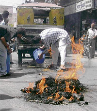 An auto that caught fire after it passed near a burning effigy in Ludhiana on Thursday.