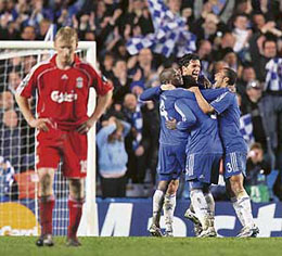 Chelsea players celebrate as Liverpool's Dirk Kuyt (L) walks back to his position after Chelsea beat Liverpool during the second leg of a UEFA Champions League semifinal game at Stamford Bridge in London on Wednesday.
