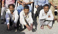 The three killers in police custody.