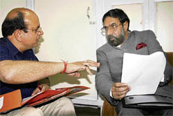 Minister of State for External Affairs Anand Sharma (right) interacts with passport officer of Shimla B.M. Sharma on Friday.