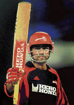 Delhi Daredevils skipper Virender Sehwag raises his bat after his fifty against the Chennai Super Kings during the IPL T20 championship match at MAC Stadium in Chennai on Friday. 
