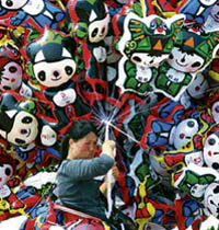 A vendor sells balloons featuring Fuwa, the mascots of the 2008 Beijing Olympic Games, in Suining, Sichuan province.