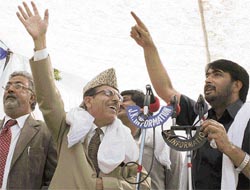 Union minister for water resources and JKPCC chief Saif-ud-din Soz and state food minister Taj Mohuddin wave to party supporters at a public rally in Anantnag