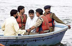 Samajwadi Party MLA Kishore Samrite (in white kurta) being arrested by the police while he attempted to commit suicide in a lake in Bhopal on Saturday.