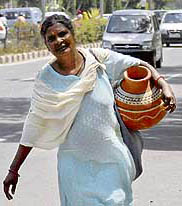 Making arrangements to quench thirst is a tiring task for this aged woman.