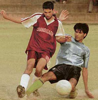 A Chandigarh Football Club player tries to snatch the ball from a fellow player during the final match of Shere-e-Punjab Trophy Tournament at the Football Stadium, Sector 17, Chandigarh, on Sunday.