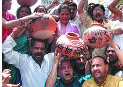 CRY FOR WATER: Activists of the Bharatiya Janata Party protest against shortage of water at Defence Colony in the Capital on Sunday.