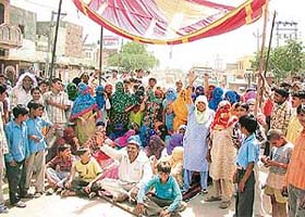 Residents of Bohar village in Rohtak district block traffic on the Rohtak-Sonepat road passing through the village in protest against the erratic power and water supply