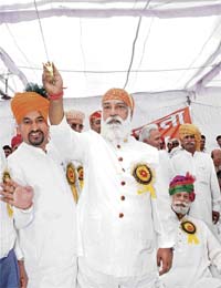 The scion of the erstwhile royal family of Udaipur, Arvind Singh Mewar, with a sword presented to him at a Rajput mahasammelan at Rajound in Kaithal