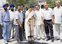 Councillor Amrit Varsha Rampal inaugurates work on laying premix in I-block market in Ludhiana on Sunday.