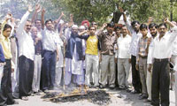 Activists of the minority cell of the Samajwadi Party stage a protest in Ludhiana on Sunday.