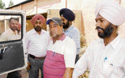 JE Ashwini Kumar (centre), who was caught by the vigilance department in Rajpura