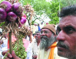 Farmers under the banner of the Bharatiya Kisan Sangh sit on a dharna for their demands at Jantar Mantar in the Capital on Monday.
