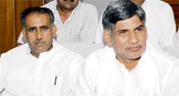 Virender Singh (right), political adviser to the Chief Minister, addresses a press conference in Karnal 