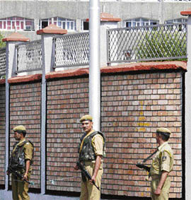 Policemen patrol outside the civil secretariat complex on the first day of the Darbar Move in Srinagar on Monday