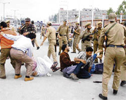 The police lathi-charges government employees for protesting against the state government for not fulfilling their demands, outside the civil secretariat in Srinagar, on Monday.