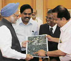 Indian Space Research Organisation chairman G. Madhavan Nair presents a picture taken by sattelite Cartosat-2A to Prime Minister Manmohan Singh during a meeting in New Delhi on Monday.