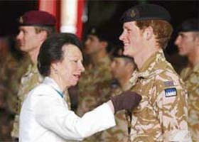 Britain's Prince Harry is awarded the Operational Service Medal for Afghanistan by his aunt, Princess Anne, during a service at the Combermere Barracks in Windsor