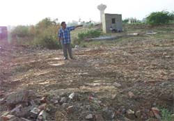 Swaranjit Singh shows his razed house at a Dera Bassi village on Tuesday.