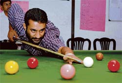 A cueist gets ready to take a shot during the snooker and billiards championship at Chandigarh Club on Tuesday.